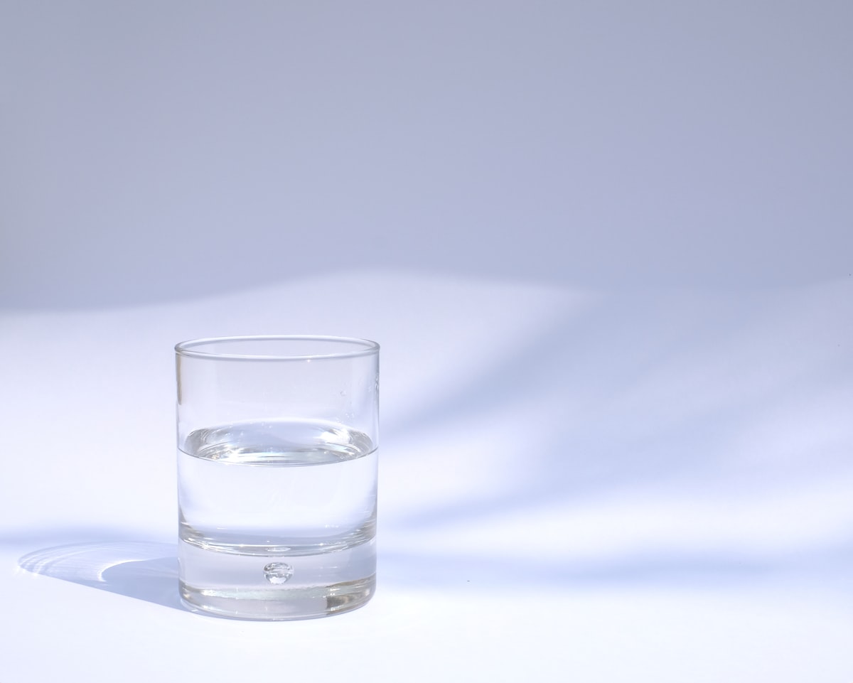 Vaso de agua transparente con luz suave