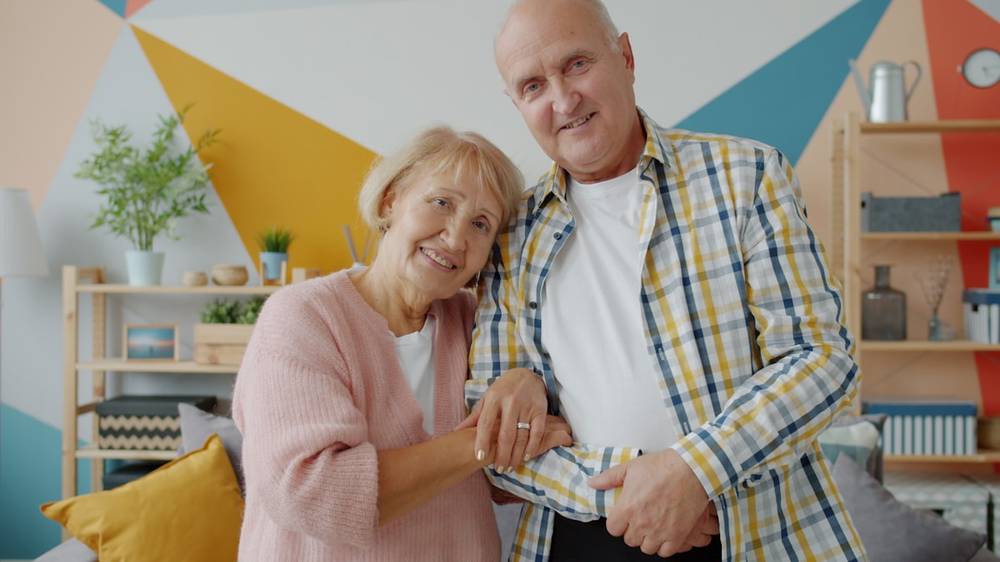 Pareja mayor sonriendo, abrazados con cariño